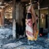 An image of Ayatollah Ali Khamenei dangles in a building damaged by Israeli strikes